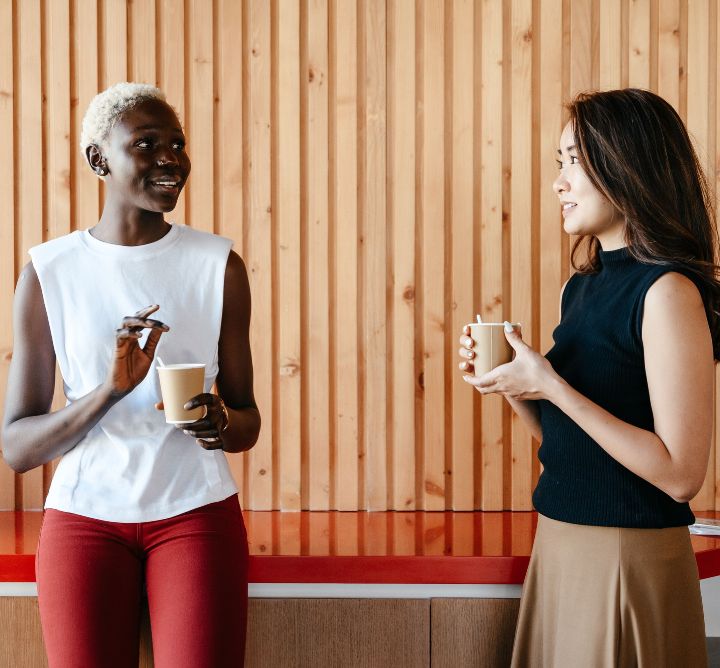 Two women drinking coffee.